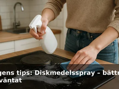 En hand som sprayar diskmedelsspray på en smutsig spishäll och torkar med mikrofiberduk.