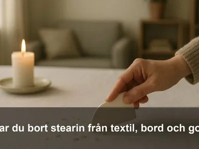 Hårda droppar av stearin på en vit duk med en hand som skrapar försiktigt med ett plastkort