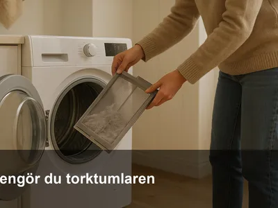 Öppen torktumlare där någon tar ut luddfiltret för rengöring i en ljus tvättstuga