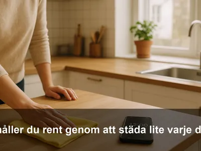 Hand som torkar av en köksbänk med mikrofiberduk medan en timer på mobilen räknar ner.